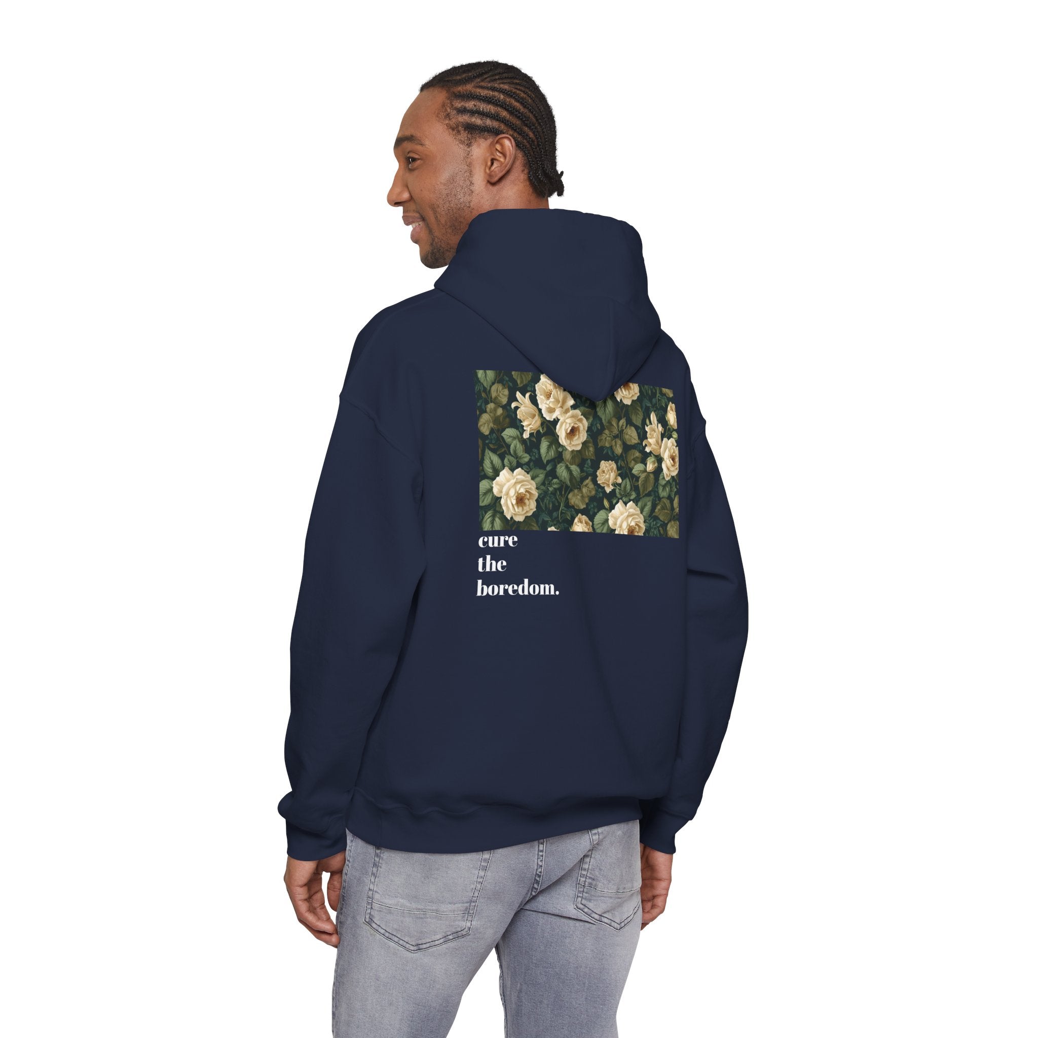 Person wearing a navy hoodie with floral design and text on the back, on a white background